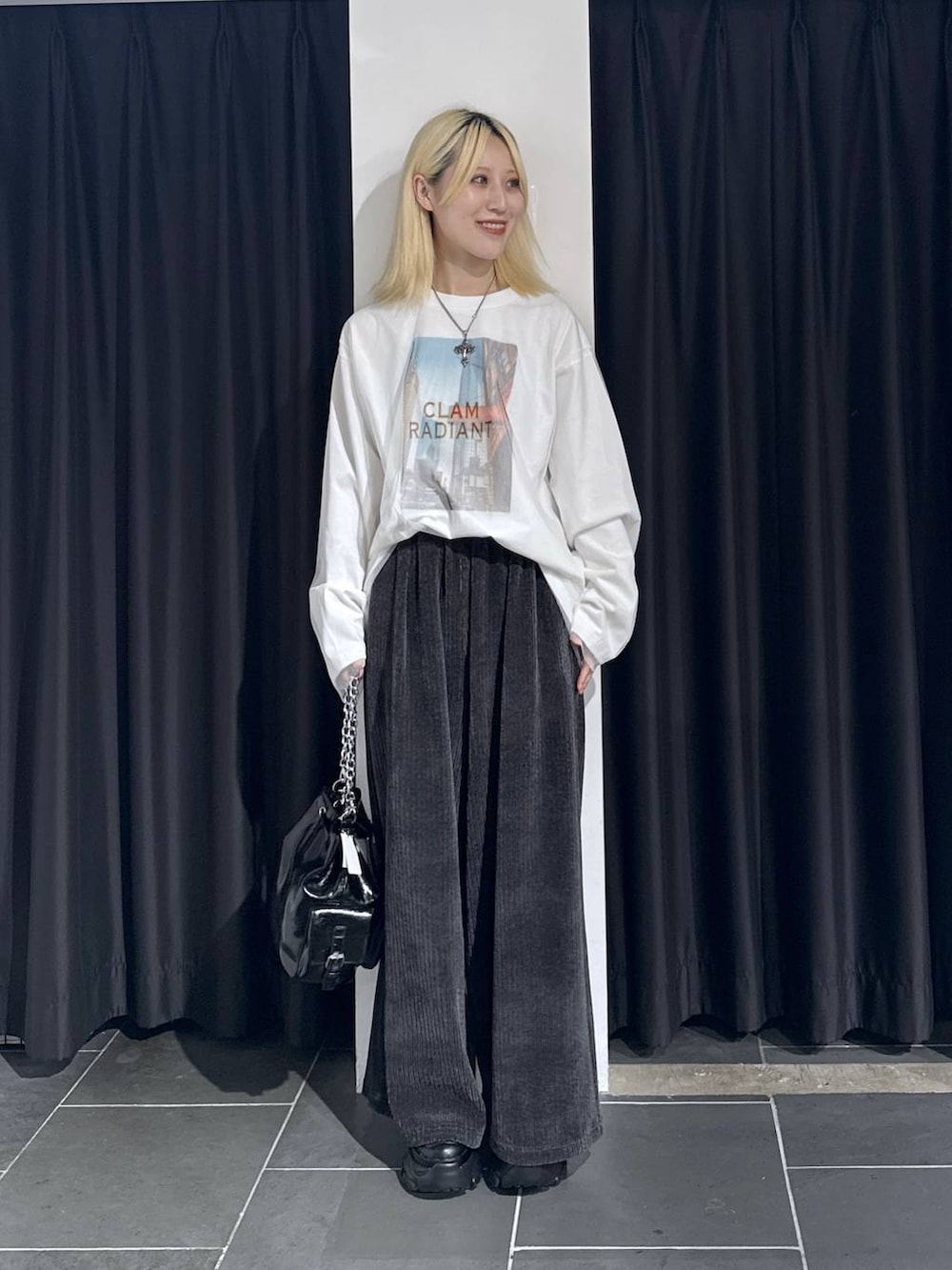 ブラック系のスニーカー、グレー系のその他パンツ、ブラック系のショルダーバッグを着用したレディースの秋コーディネートの2枚目の写真