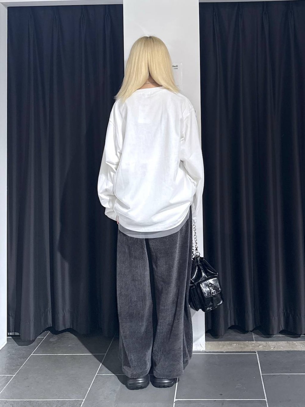 ブラック系のスニーカー、グレー系のその他パンツ、ブラック系のショルダーバッグを着用したレディースの秋コーディネートの4枚目の写真