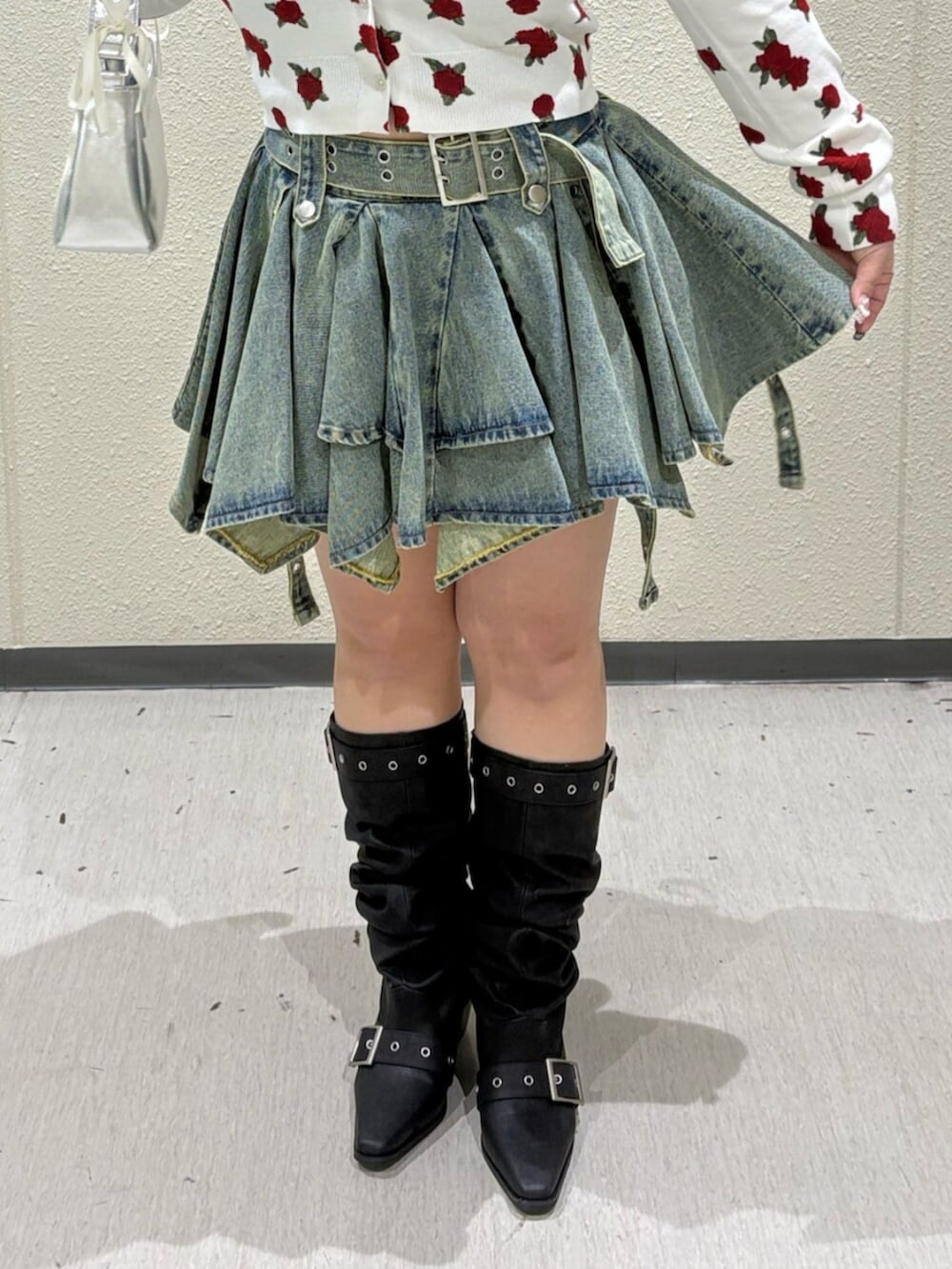 シルバー系のハンドバッグ、ホワイト系のカーディガン/ボレロ、ブルー系のデニムスカートを着用したレディースの春コーディネートの7枚目の写真