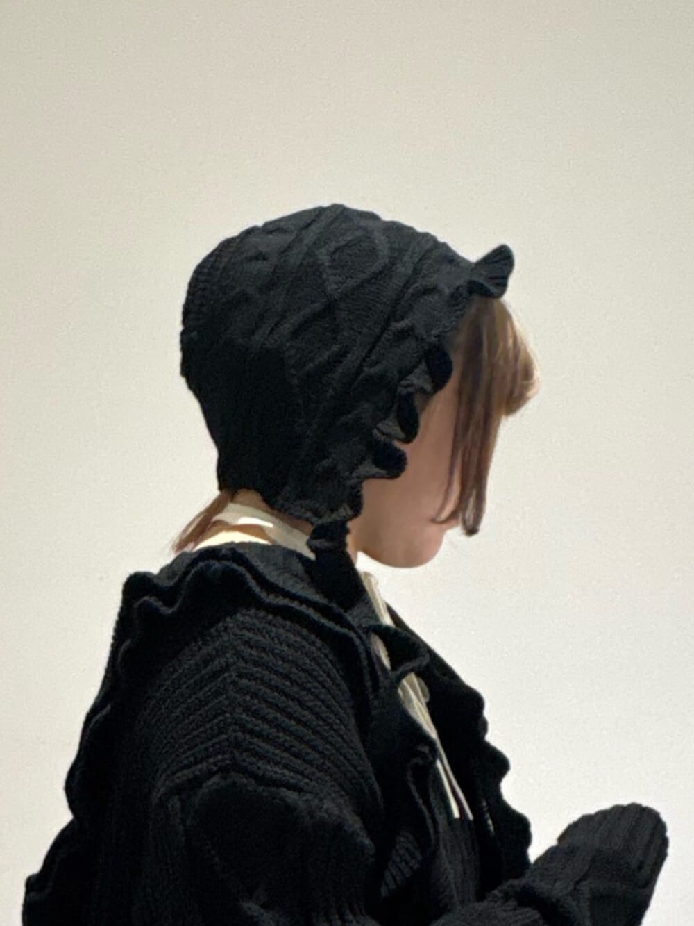 ホワイト系のニット/セーター、ブラック系のブーツ、ブラック系のニット/セーターを着用したレディースの冬コーディネートの6枚目の写真