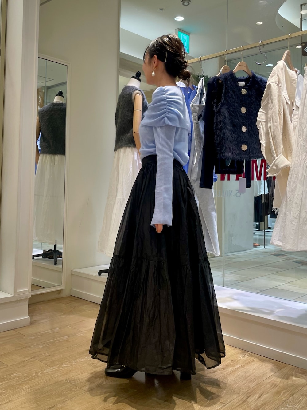 グレー系のニット/セーター、ベージュ系のショルダーバッグを着用したレディースの秋コーディネートの9枚目の写真