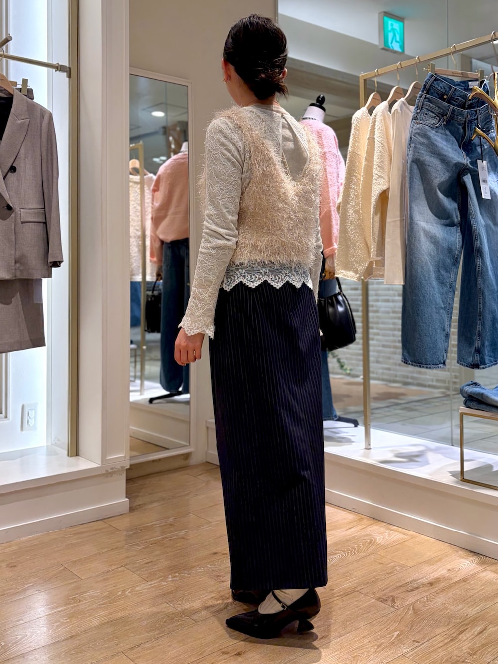 ホワイト系のシャツ/ブラウス、ホワイト系のTシャツ/カットソー、ベージュ系のニット/セーターを着用したレディースの冬コーディネートの3枚目の写真