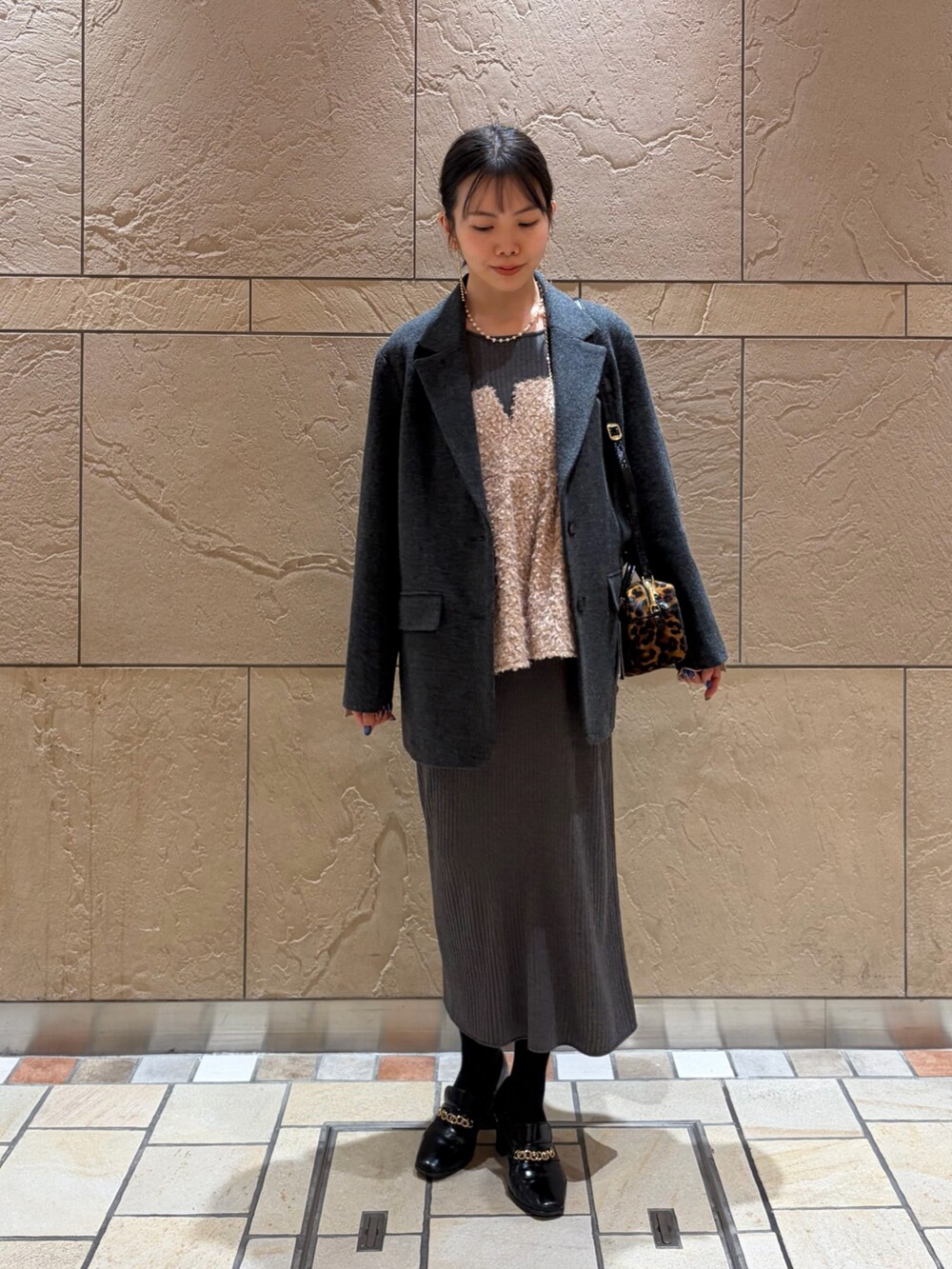 グレー系のテーラードジャケット、その他のボストンバッグ、ベージュ系のキャミソールを着用したレディースの冬コーディネートの5枚目の写真