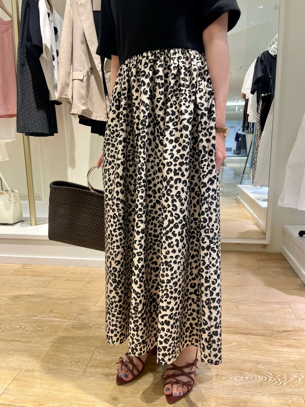 ブラック系のワンピース、ブラウン系のかごバッグを着用したレディースの夏コーディネートの5枚目の写真