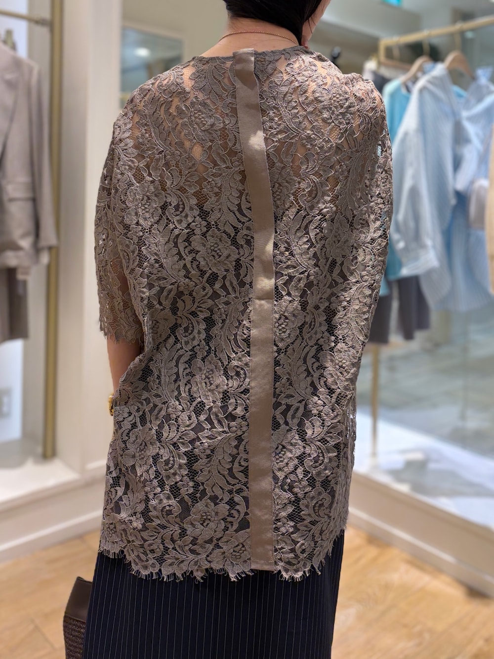 ブルー系のスカート、ブラウン系のショルダーバッグ、その他のネックレスを着用したレディースの冬コーディネートの9枚目の写真