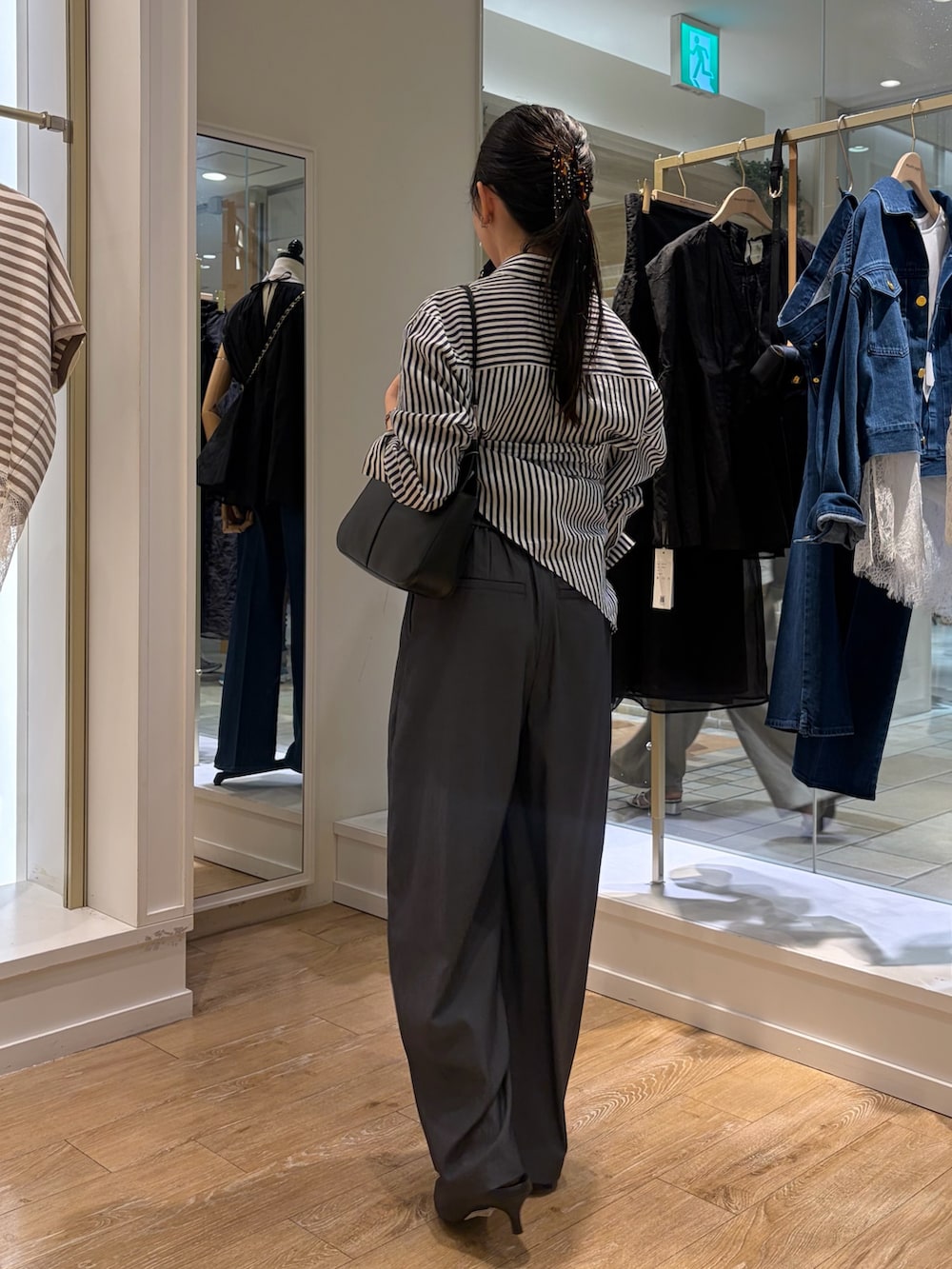 ブルー系のシャツ/ブラウス、ブラック系のショルダーバッグ、グレー系のその他パンツを着用したレディースの秋コーディネートの3枚目の写真