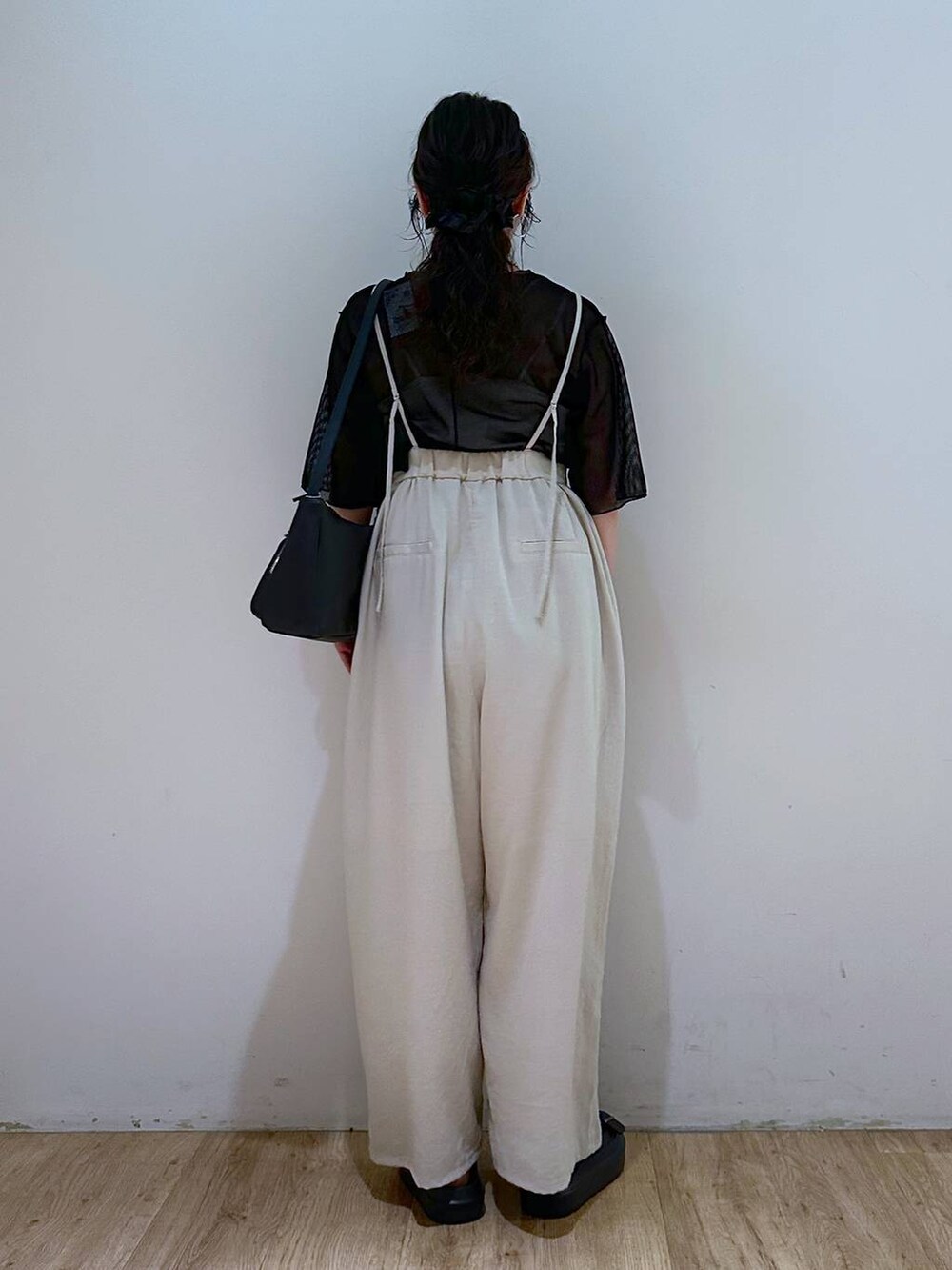 ベージュ系のサロペット/オーバーオール、ブラック系のサンダル、ブラック系のTシャツ/カットソーを着用したレディースの夏コーディネートの3枚目の写真