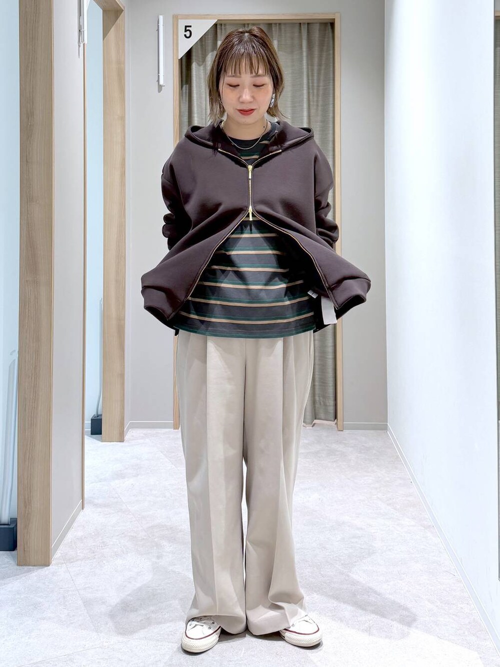 ベージュ系のその他パンツ、ブラウン系のパーカー、グレー系のTシャツ/カットソーを着用したレディースの冬コーディネートの5枚目の写真