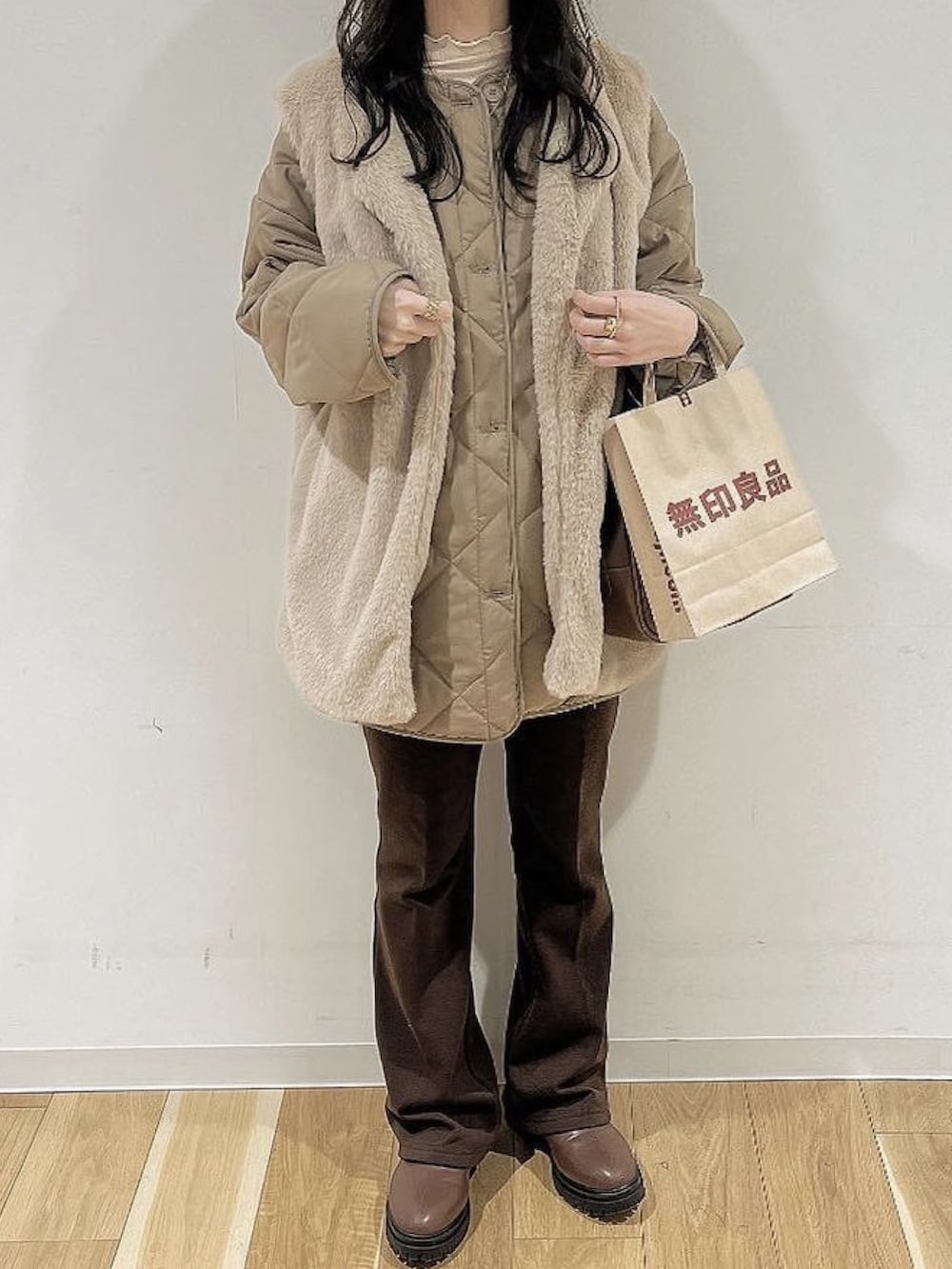 ブラウン系のダウンジャケット/コート、ブラウン系のパンツ、ブラウン系のブーツを着用したレディースの冬コーディネートの2枚目の写真