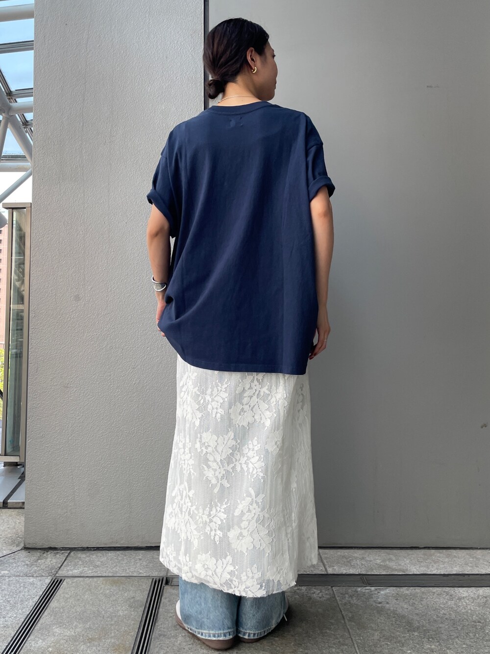 ブルー系のTシャツ/カットソー、ホワイト系のワンピース、ブルー系のデニムパンツを着用したレディースの夏コーディネートの3枚目の写真