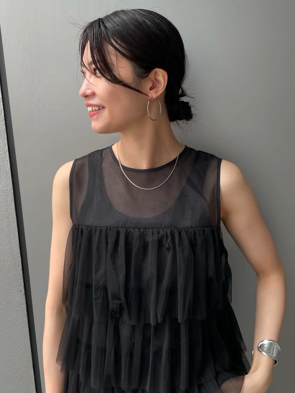 ブラック系のシャツ/ブラウス、ブルー系のデニムパンツを着用したレディースの夏コーディネートの5枚目の写真