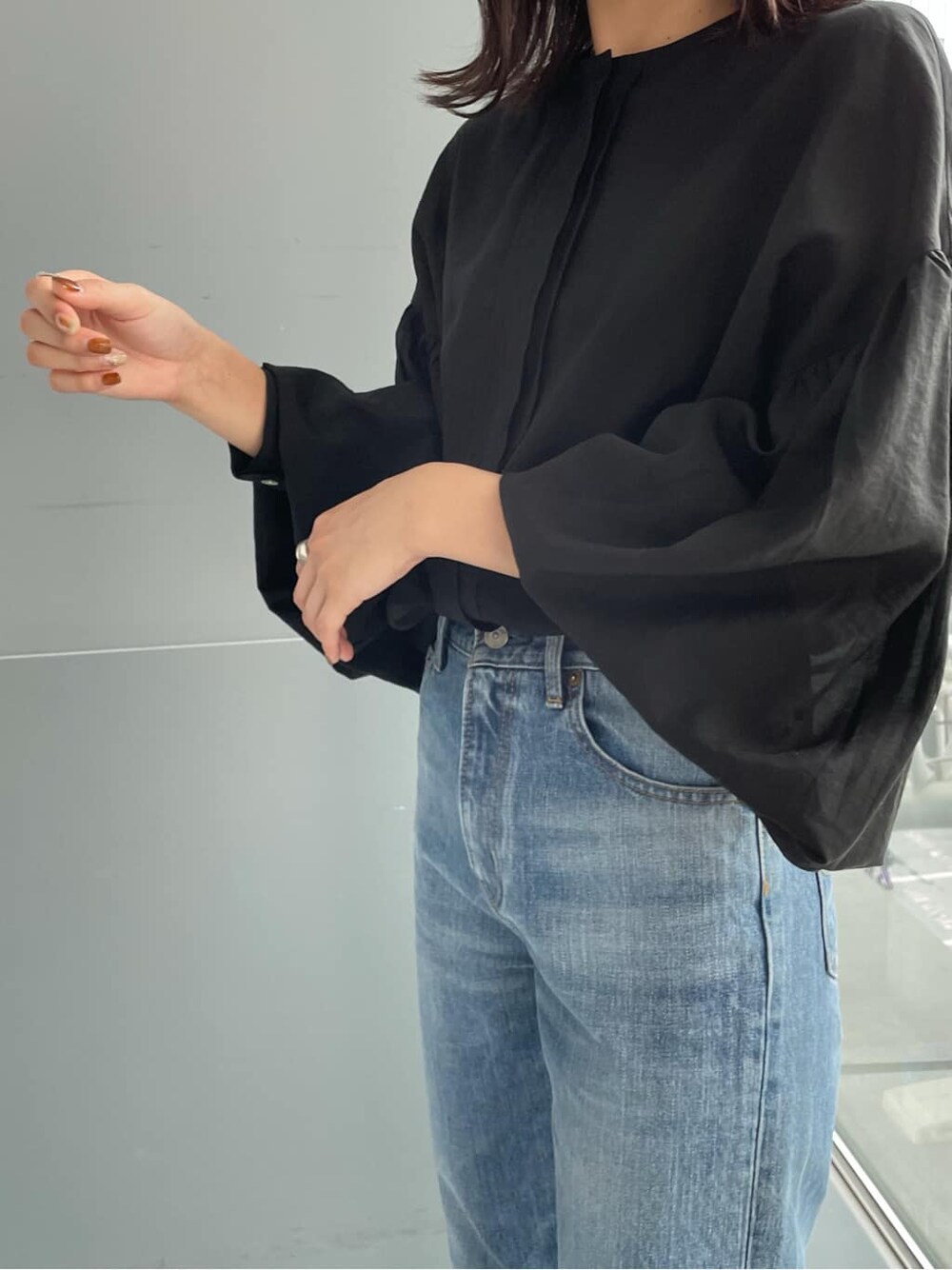 イエロー系のテーラードジャケット、ブラック系のシャツ/ブラウス、ブラック系のブーツを着用したレディースの夏コーディネートの2枚目の写真