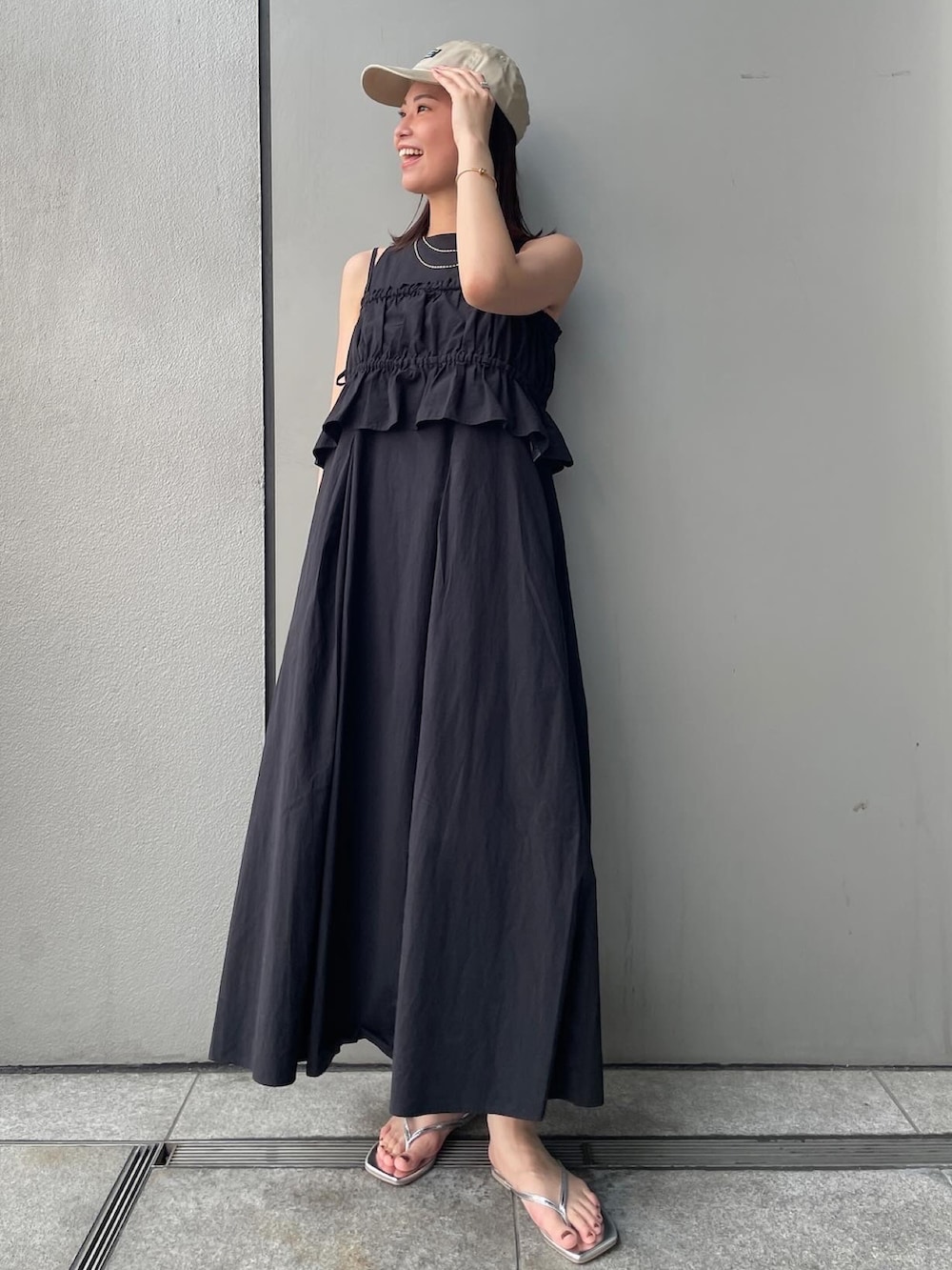 ブラック系のワンピース、シルバー系のサンダルを着用したレディースの春コーディネートの2枚目の写真