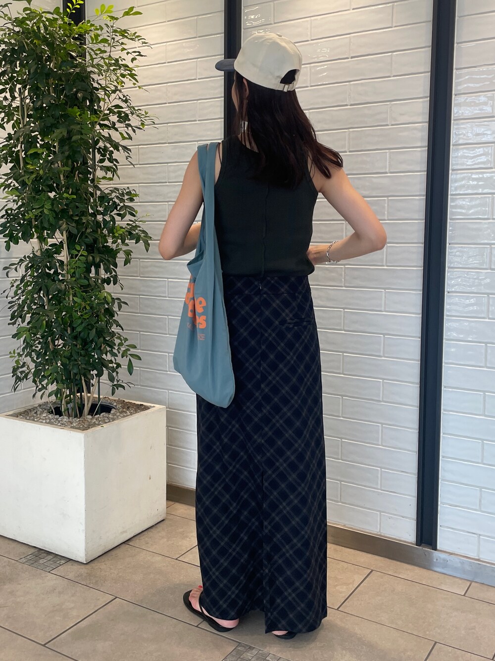 ブルー系のスカート、グレー系のタンクトップ、ブルー系のトートバッグを着用したレディースの夏コーディネートの3枚目の写真