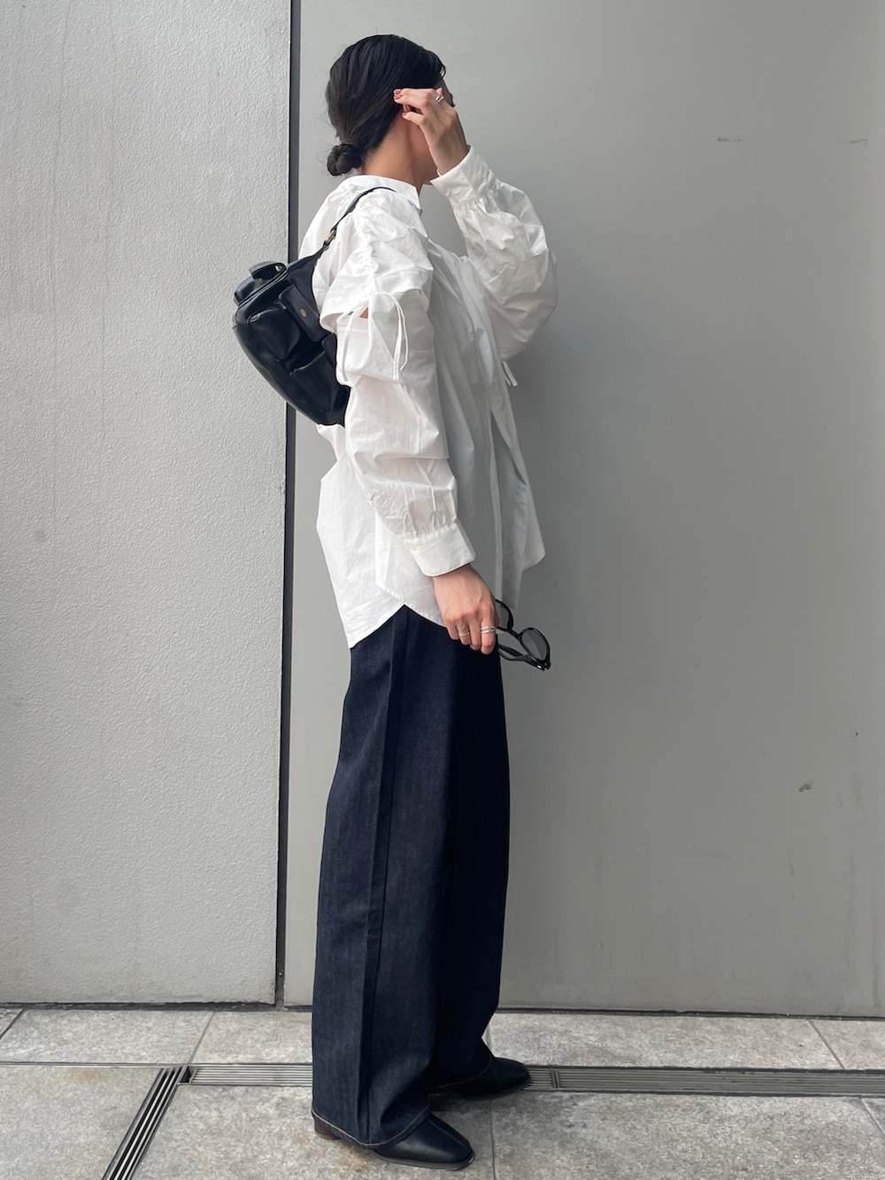 ブルー系のデニムパンツ、ホワイト系のシャツ/ブラウス、ホワイト系のキャミソールを着用したレディースの夏コーディネートの2枚目の写真