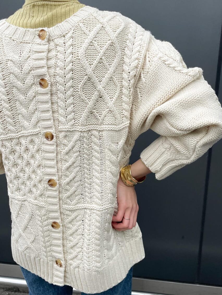 ブルー系のデニムパンツ、イエロー系のニット/セーター、ホワイト系のカーディガン/ボレロを着用したレディースの冬コーディネートの5枚目の写真