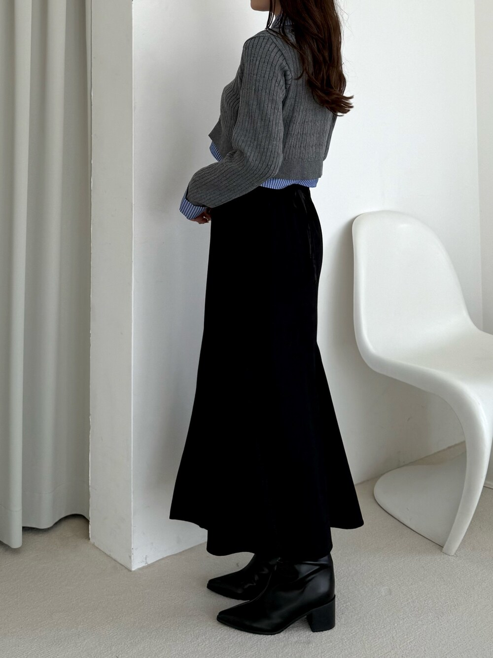 グレー系のカーディガン/ボレロ、ブラック系のスカートを着用したレディースの秋コーディネートの3枚目の写真