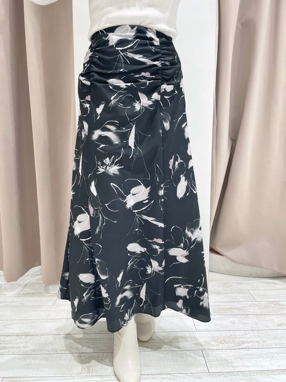 ブラック系のその他シューズ、ホワイト系のニット/セーター、ブラック系のスカートを着用したレディースの秋コーディネートの7枚目の写真