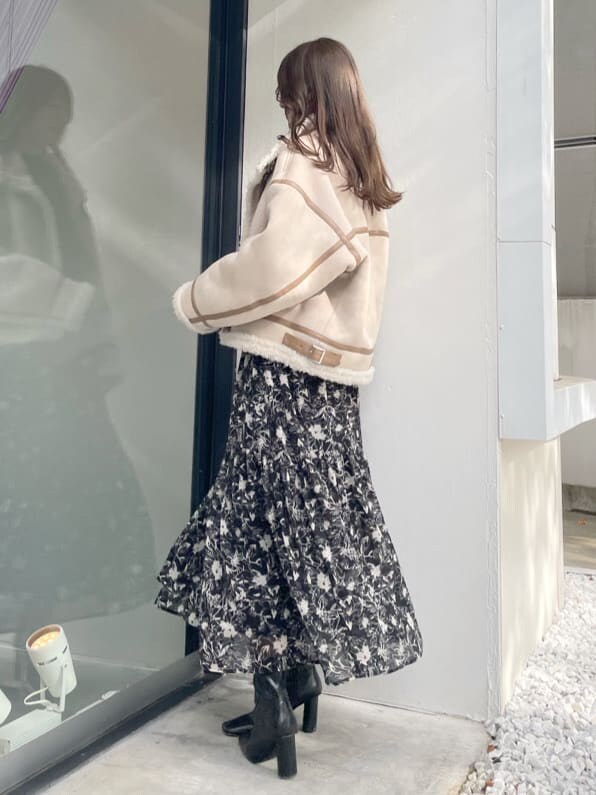 ベージュ系のムートンコート、ベージュ系のムートンコート、ブラック系のワンピースを着用したレディースの秋コーディネートの3枚目の写真