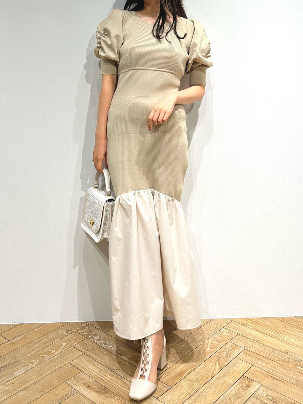 ブラウン系のテーラードジャケット、ベージュ系のワンピース、ホワイト系のブーツを着用したレディースの夏コーディネートの5枚目の写真