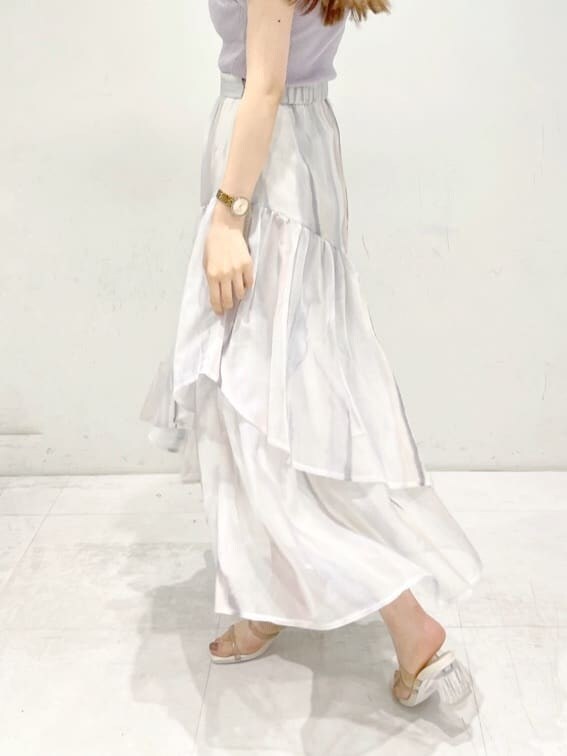 ピンク系のスカート、ベージュ系のサンダル、パープル系のニット/セーターを着用したレディースの春コーディネートの9枚目の写真