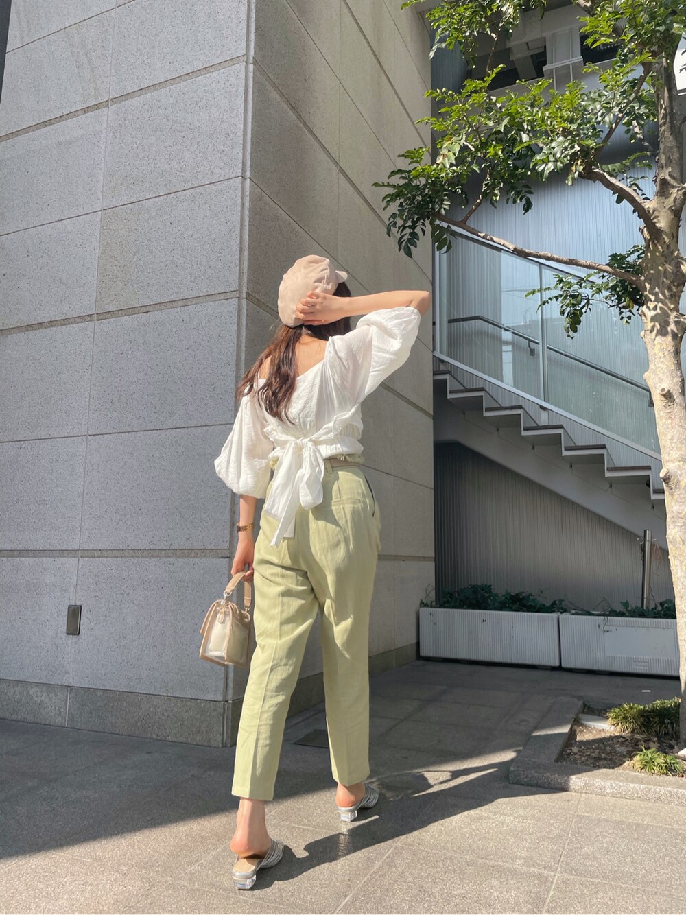 イエロー系のその他パンツ、ホワイト系のシャツ/ブラウス、シルバー系のサンダルを着用したレディースの春コーディネートの3枚目の写真