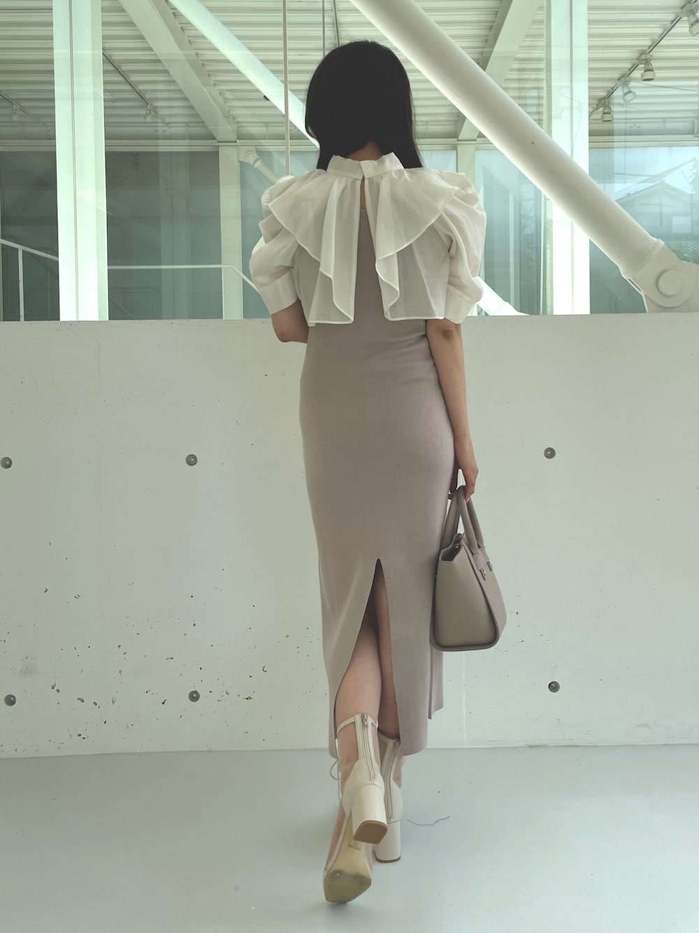ホワイト系のブーツ、ベージュ系のワンピース、ベージュ系のハンドバッグを着用したレディースの夏コーディネートの4枚目の写真