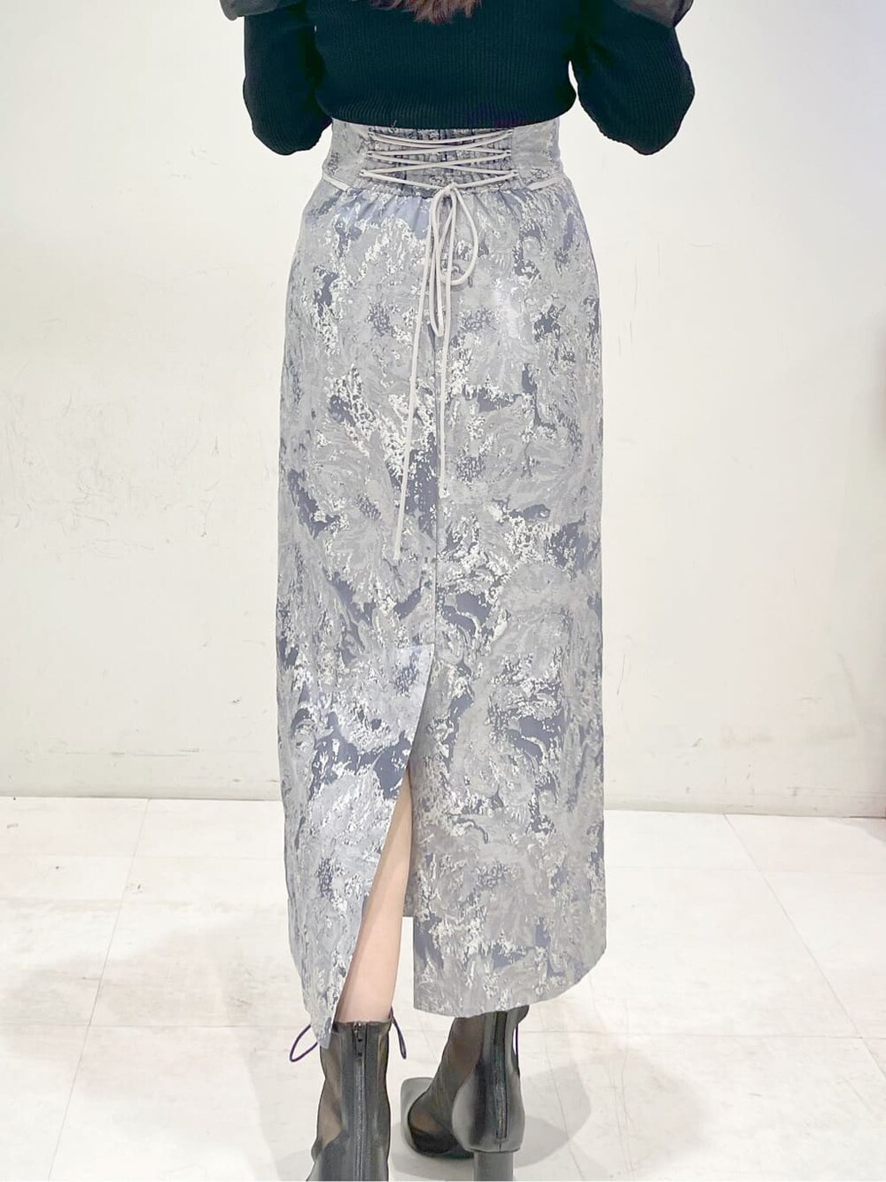 ブラック系のその他シューズ、ブルー系のスカート、ブラック系のニット/セーターを着用したレディースの冬コーディネートの6枚目の写真