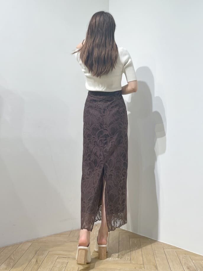 ブラウン系のスカート、ホワイト系のニット/セーターを着用したレディースの夏コーディネートの2枚目の写真