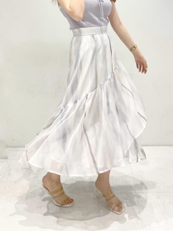 ピンク系のスカート、ベージュ系のサンダル、パープル系のニット/セーターを着用したレディースの春コーディネートの8枚目の写真