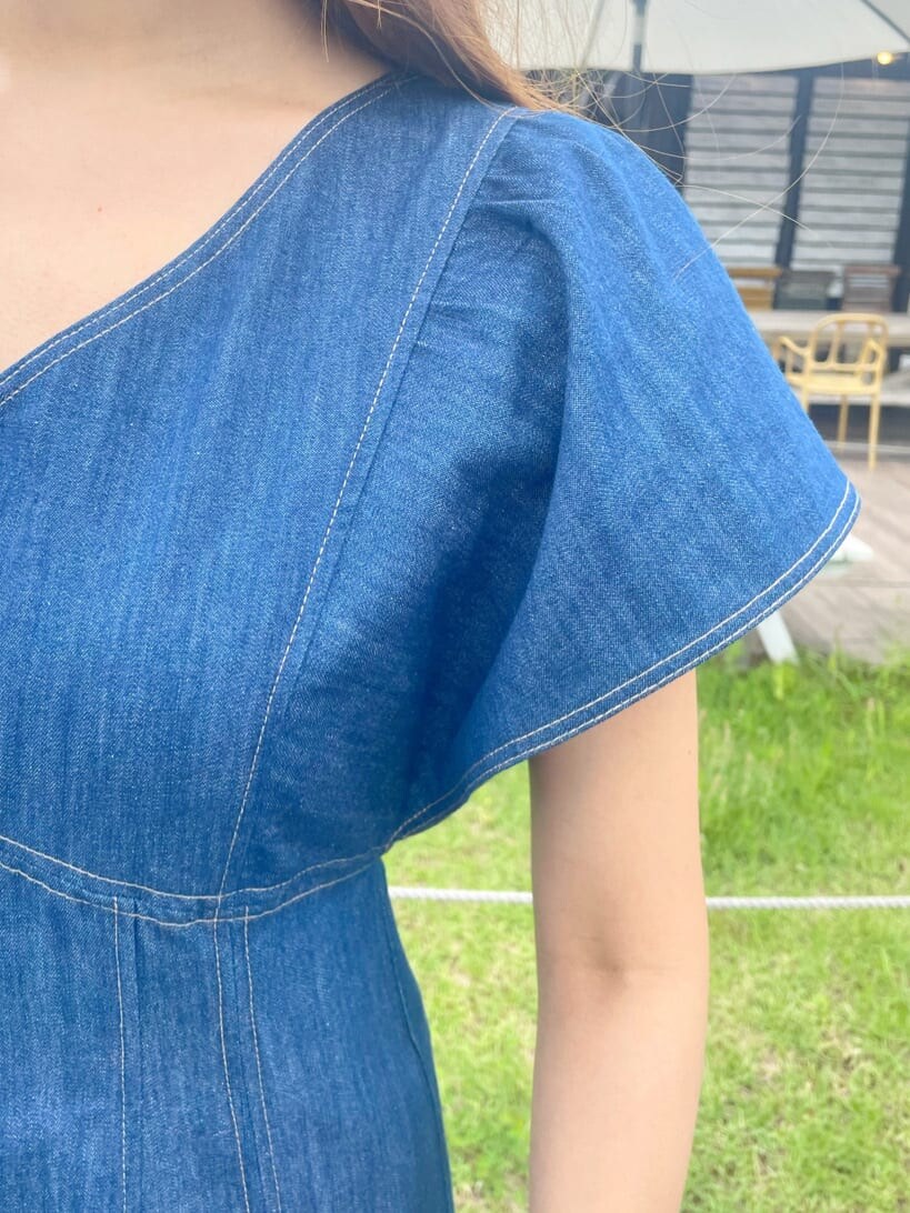 ホワイト系のハンドバッグ、ホワイト系のサンダル、ブルー系のワンピースを着用したレディースの夏コーディネートの8枚目の写真