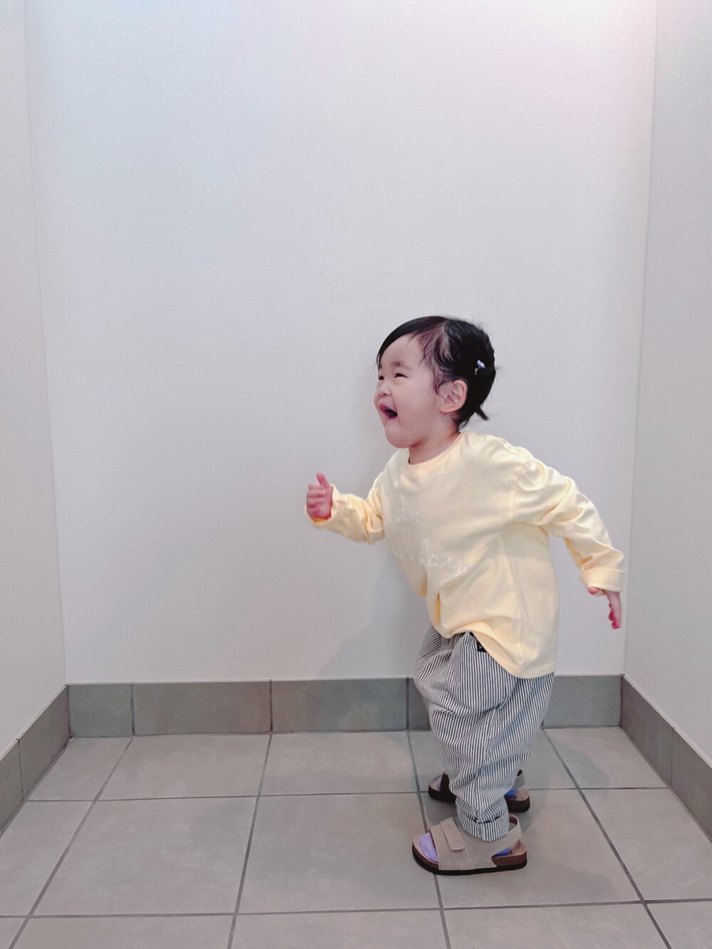 イエロー系のTシャツ/カットソー、ブルー系のパンツ、ベージュ系のサンダルを着用したキッズの春コーディネートの5枚目の写真