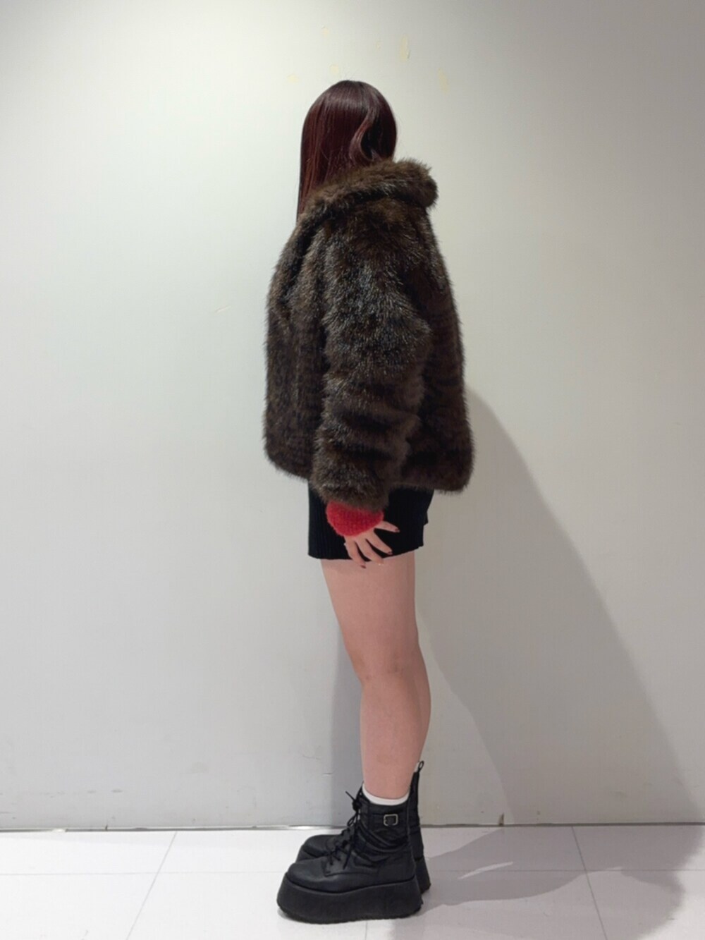 ブラック系のブーツ、その他のその他アウター、レッド系のニット/セーターを着用したレディースの冬コーディネートの2枚目の写真