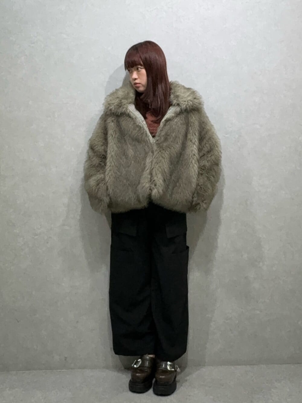 グレー系のブルゾン、ブラック系のカーゴパンツ、ブラウン系のローファーを着用したレディースの夏コーディネートの4枚目の写真