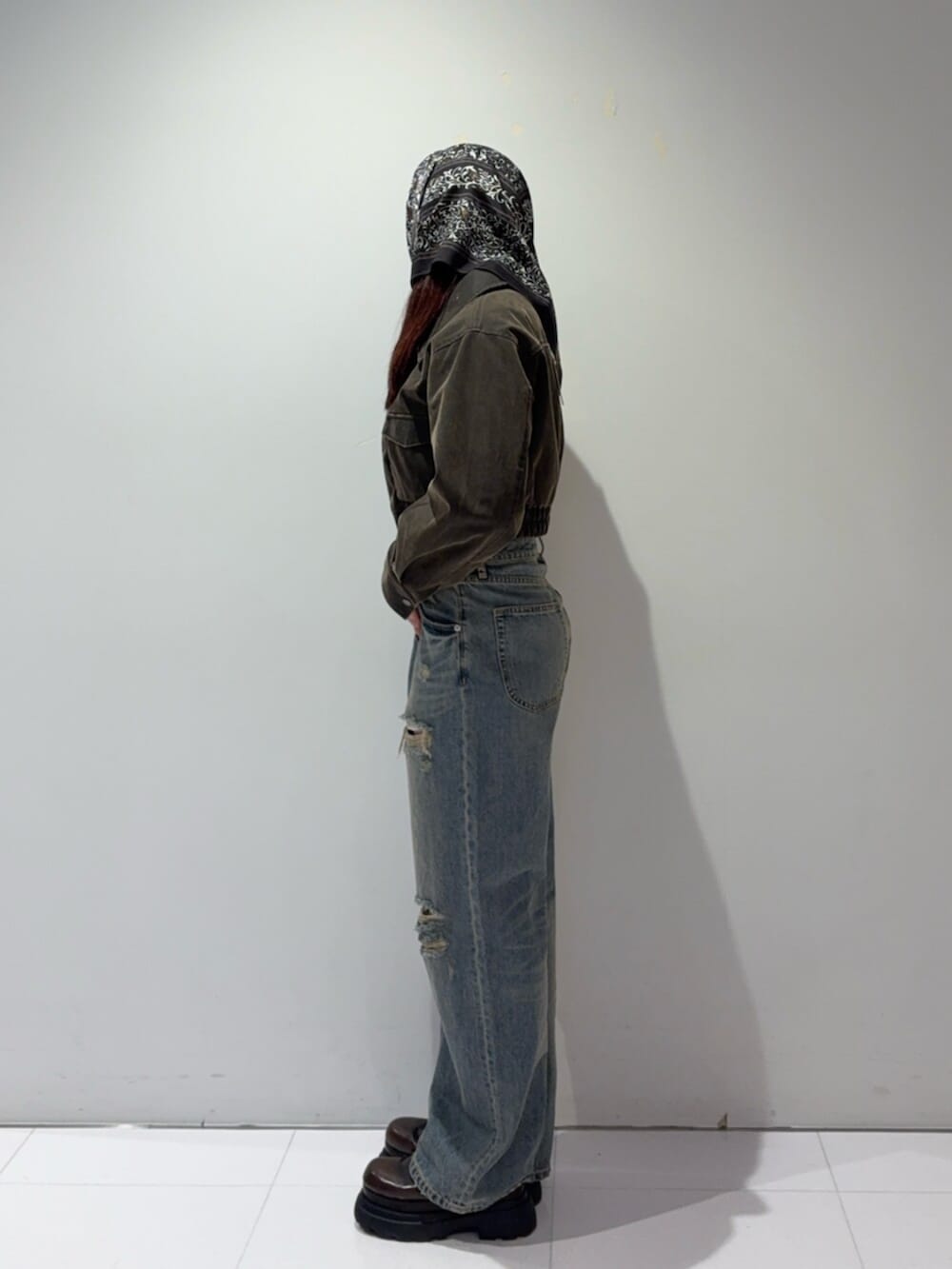 ブラウン系のローファー、ブラウン系のブルゾン、ブルー系のデニムパンツを着用したレディースの秋コーディネートの2枚目の写真