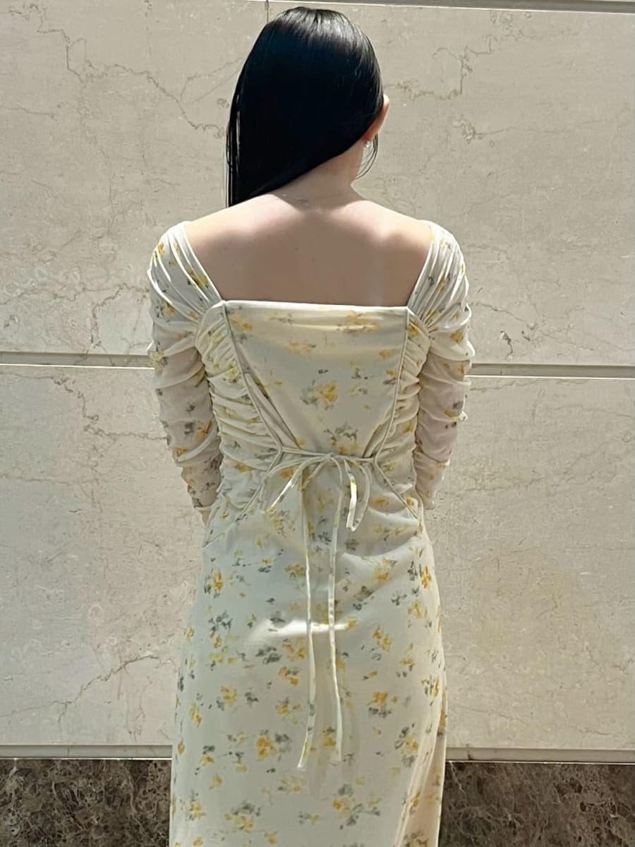 イエロー系のワンピース、その他のピアス（両耳用）を着用したレディースの冬コーディネートの6枚目の写真