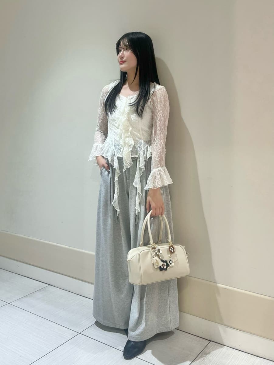 ブラック系のブーツ、ホワイト系のトレンチコート、グレー系のその他パンツを着用したレディースの冬コーディネートの7枚目の写真