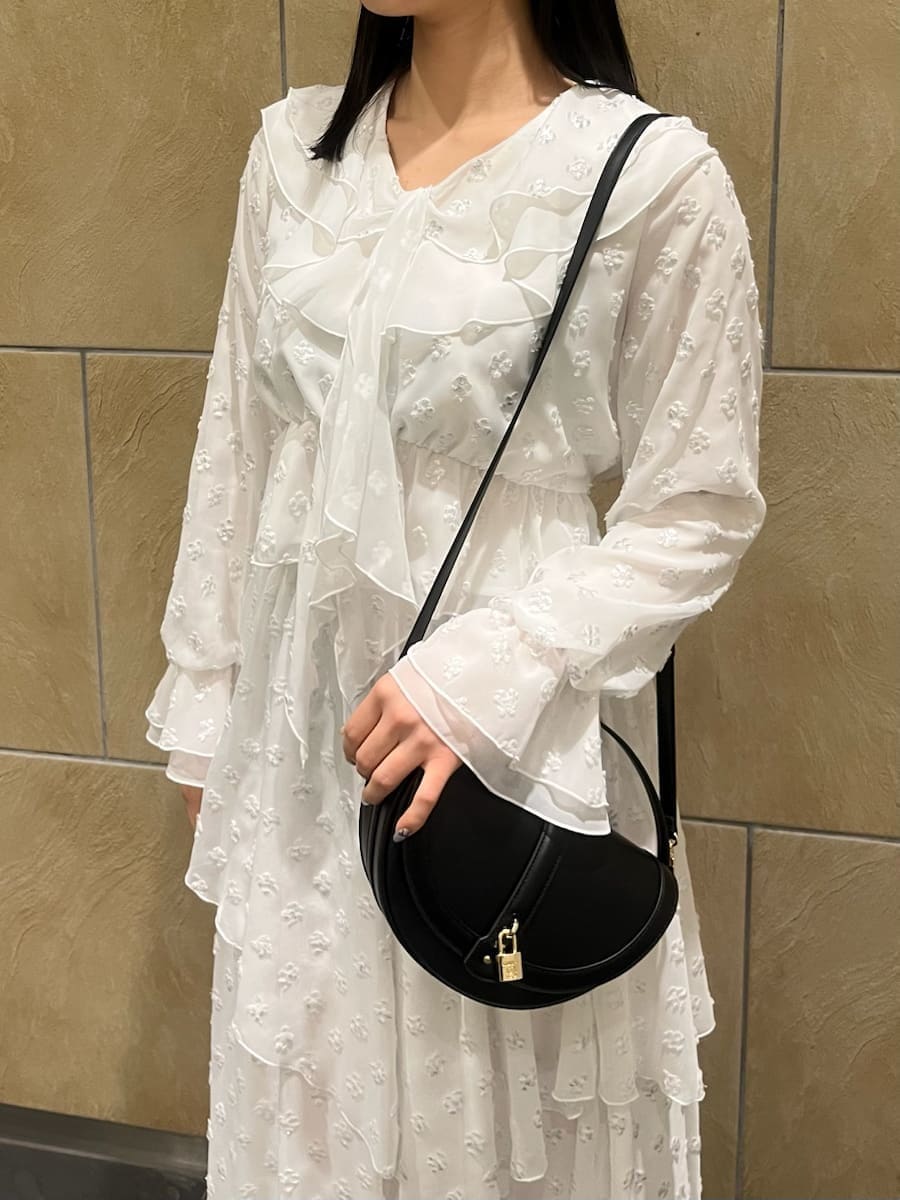 ブラック系のブーツ、ブラック系のハンドバッグ、シルバー系のスカートを着用したレディースの冬コーディネートの7枚目の写真