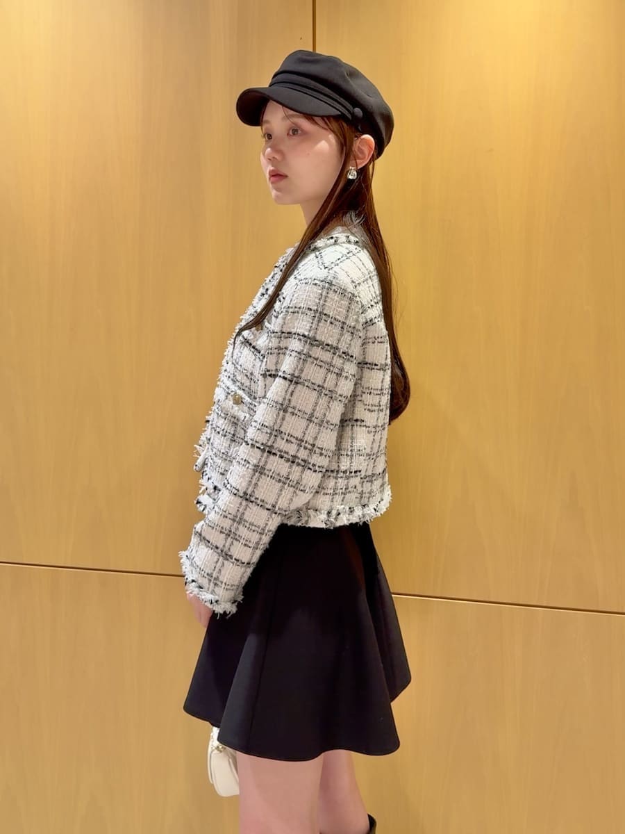 ブラック系のブーツ、ホワイト系のノーカラージャケット、ブラック系のその他パンツを着用したレディースの冬コーディネートの6枚目の写真