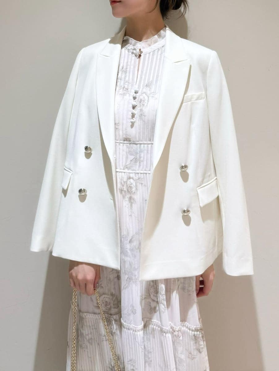 ホワイト系のテーラードジャケット、ピンク系のワンピース、ホワイト系のショルダーバッグを着用したレディースの春コーディネートの5枚目の写真