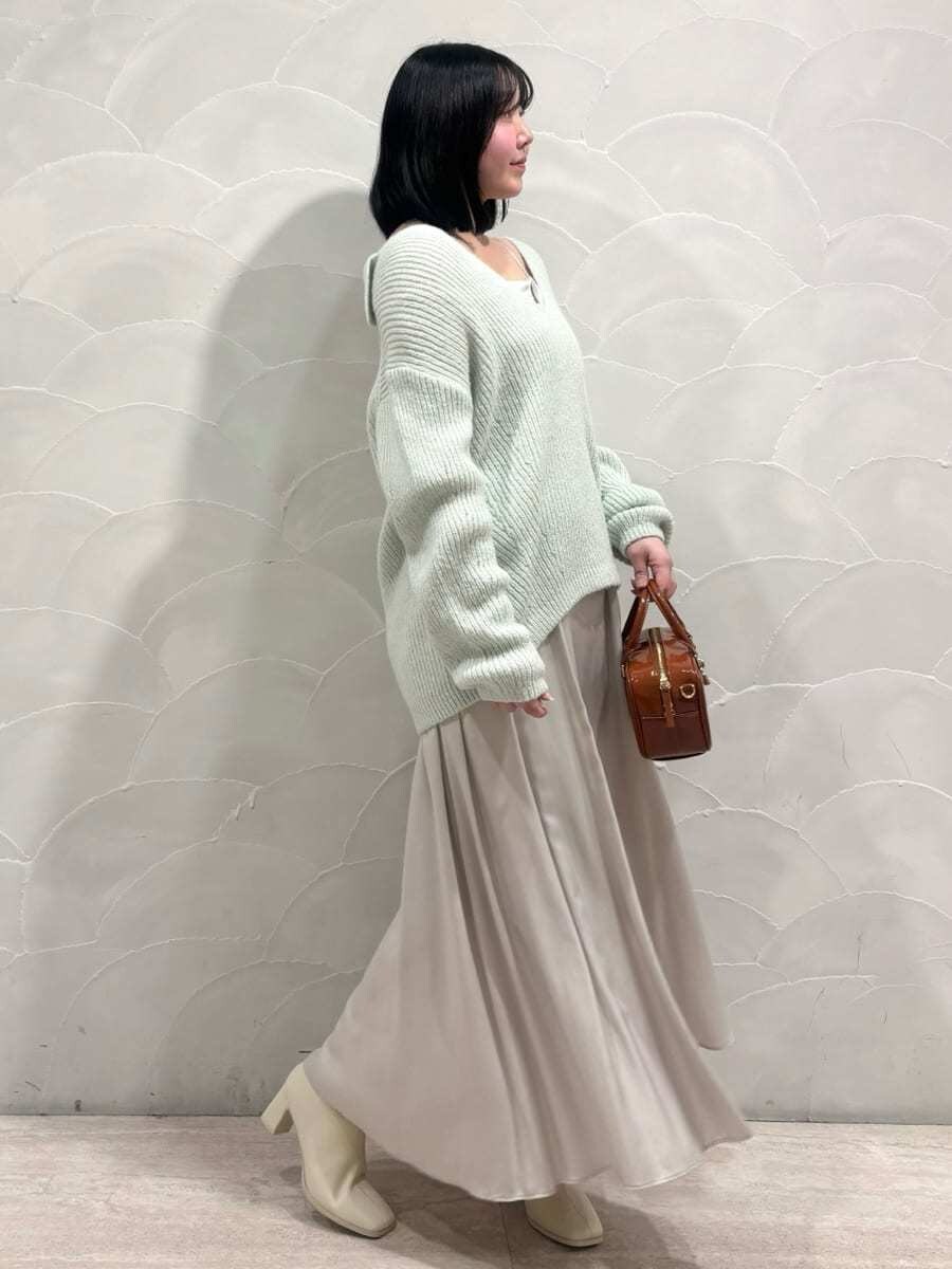 ブラウン系のボストンバッグ、グリーン系のワンピースを着用したレディースの冬コーディネートの2枚目の写真