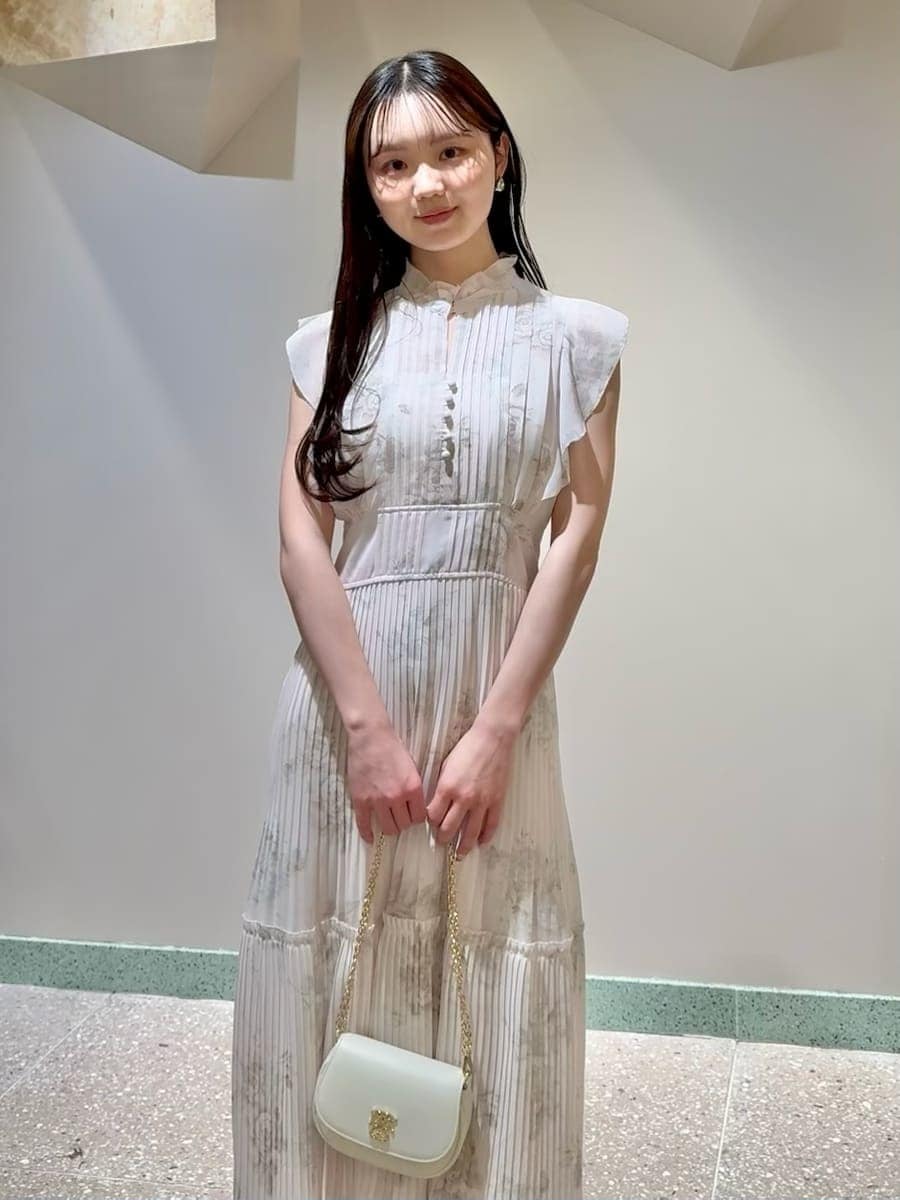 ピンク系のワンピース、ブラウン系のパンプス、ホワイト系のショルダーバッグを着用したレディースの春コーディネートの4枚目の写真