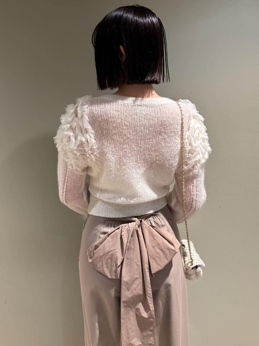 ホワイト系のカーディガン/ボレロ、ホワイト系のショルダーバッグ、ブラウン系のその他パンツを着用したレディースの冬コーディネートの6枚目の写真