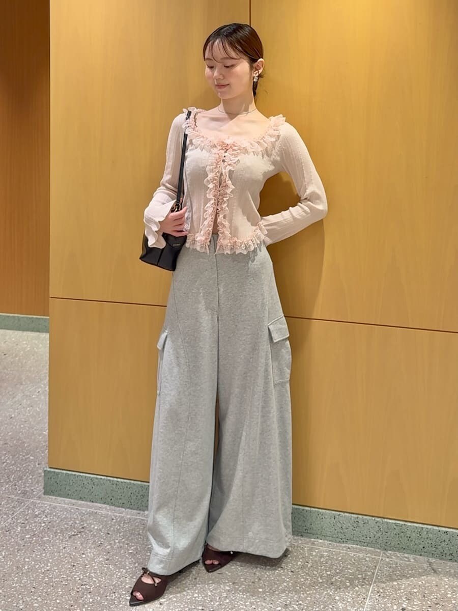 グレー系のその他パンツ、ピンク系のニット/セーター、ブラック系のショルダーバッグを着用したレディースの夏コーディネートの2枚目の写真