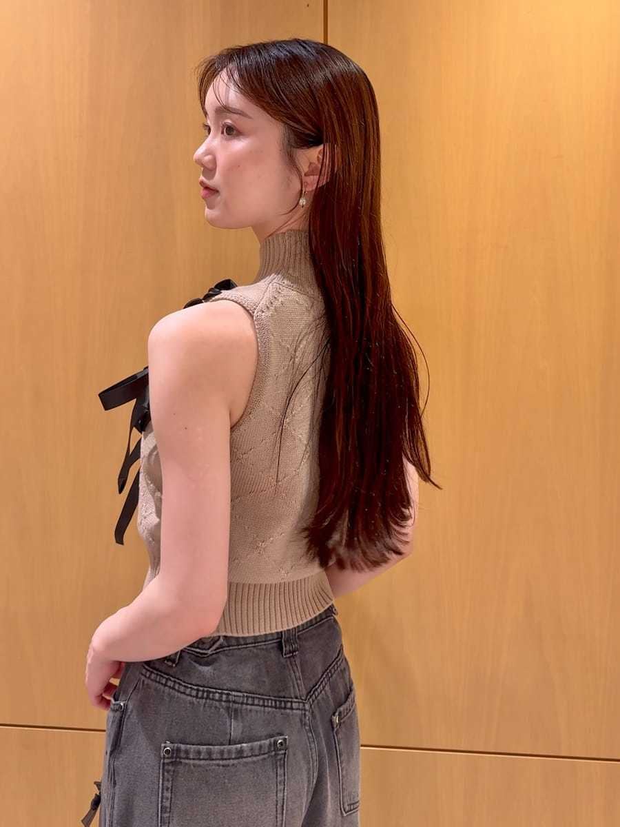ブラック系のショルダーバッグ、ブラック系のその他パンツ、ベージュ系のニット/セーターを着用したレディースの夏コーディネートの6枚目の写真