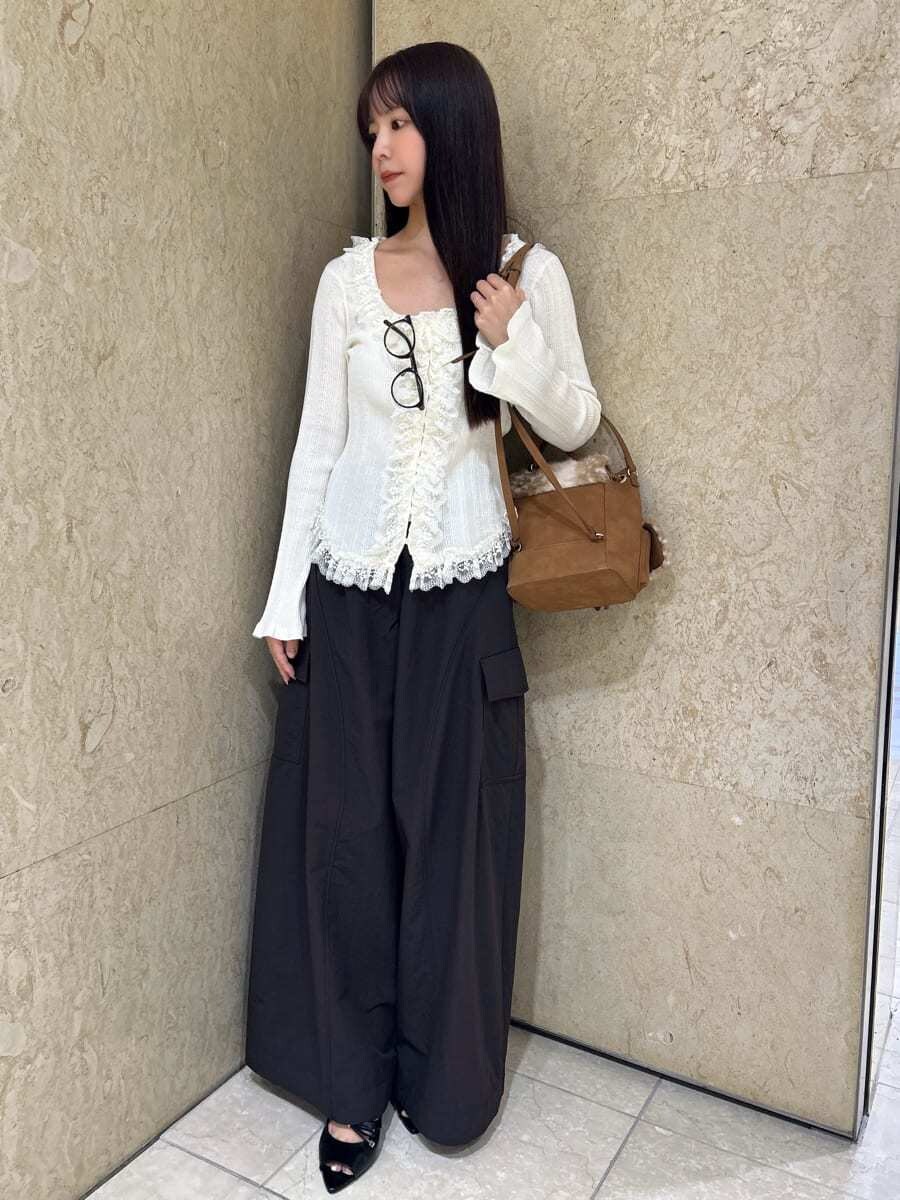 ブラウン系のその他パンツ、ホワイト系のニット/セーター、ブラック系のサンダルを着用したレディースの夏コーディネートの2枚目の写真