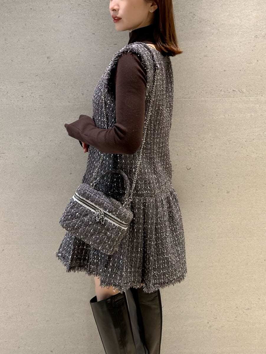 グレー系のワンピース、ブラウン系のニット/セーター、グレー系のハンドバッグを着用したレディースの秋コーディネートの3枚目の写真