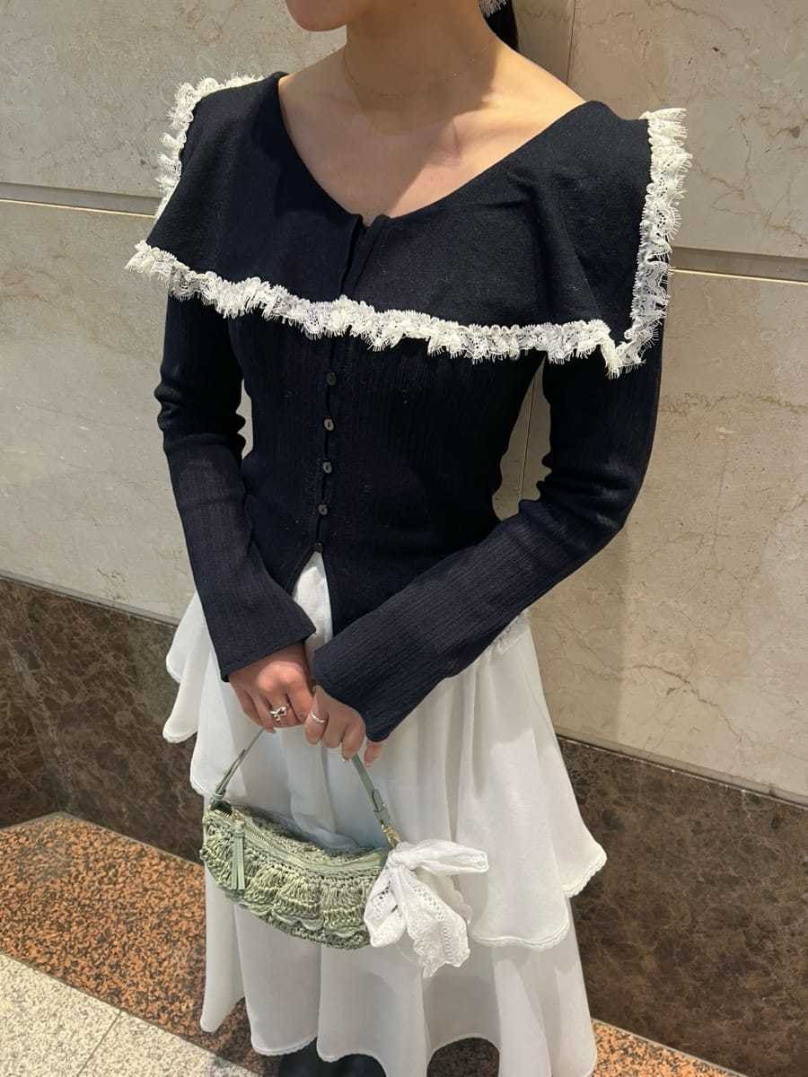 ホワイト系のスカート、ブルー系のニット/セーター、その他のピアス（両耳用）を着用したレディースの冬コーディネートの6枚目の写真