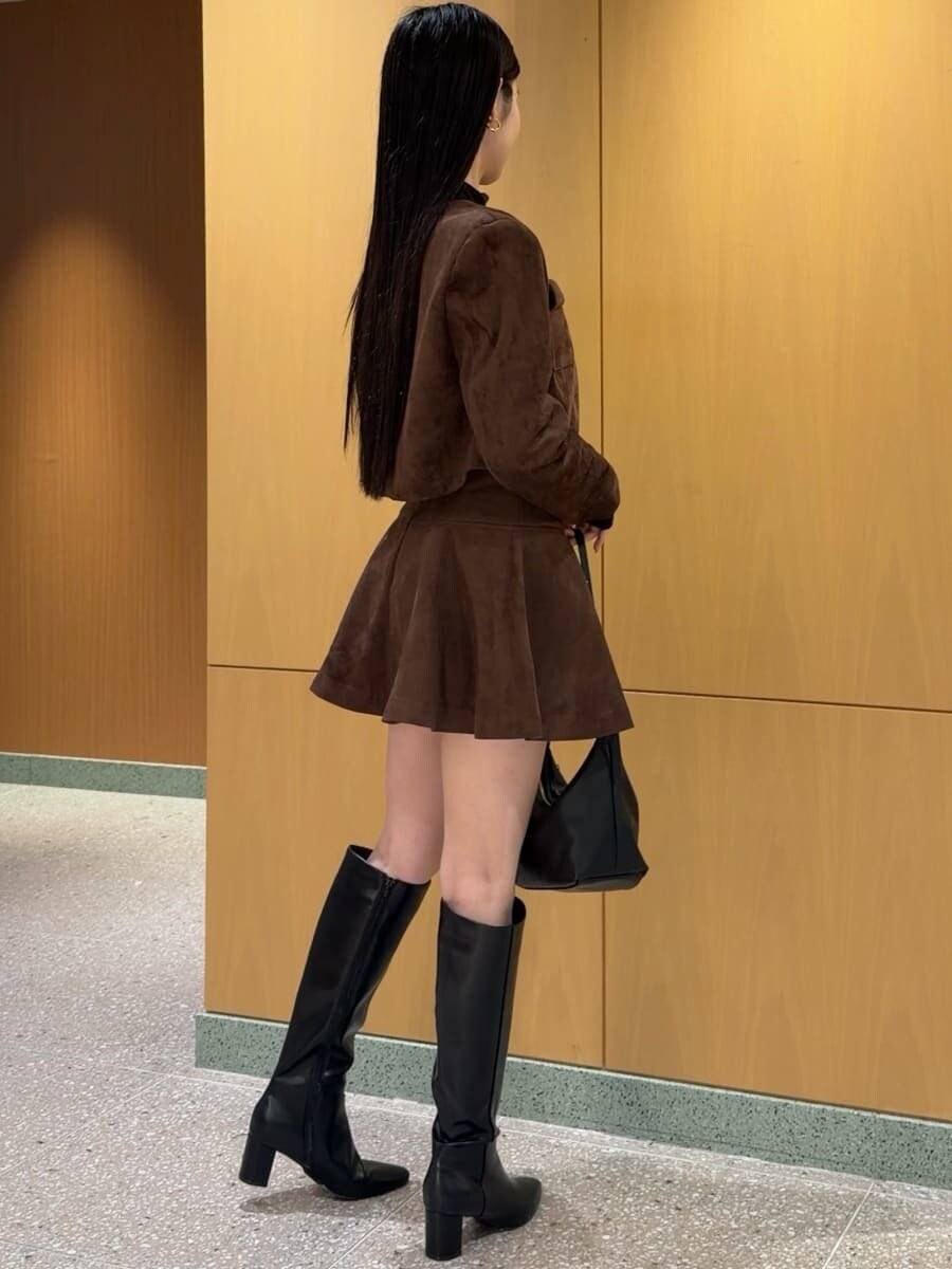 ブラウン系のノーカラージャケット、ブラウン系のその他パンツ、ブラック系のブーツを着用したレディースの秋コーディネートの3枚目の写真