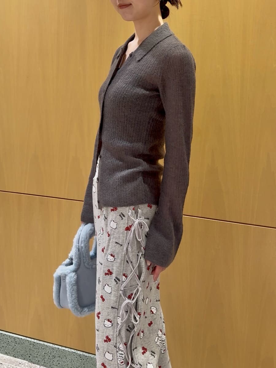 グレー系のニット/セーター、グレー系のその他パンツ、ブルー系のハンドバッグを着用したレディースの秋コーディネートの5枚目の写真